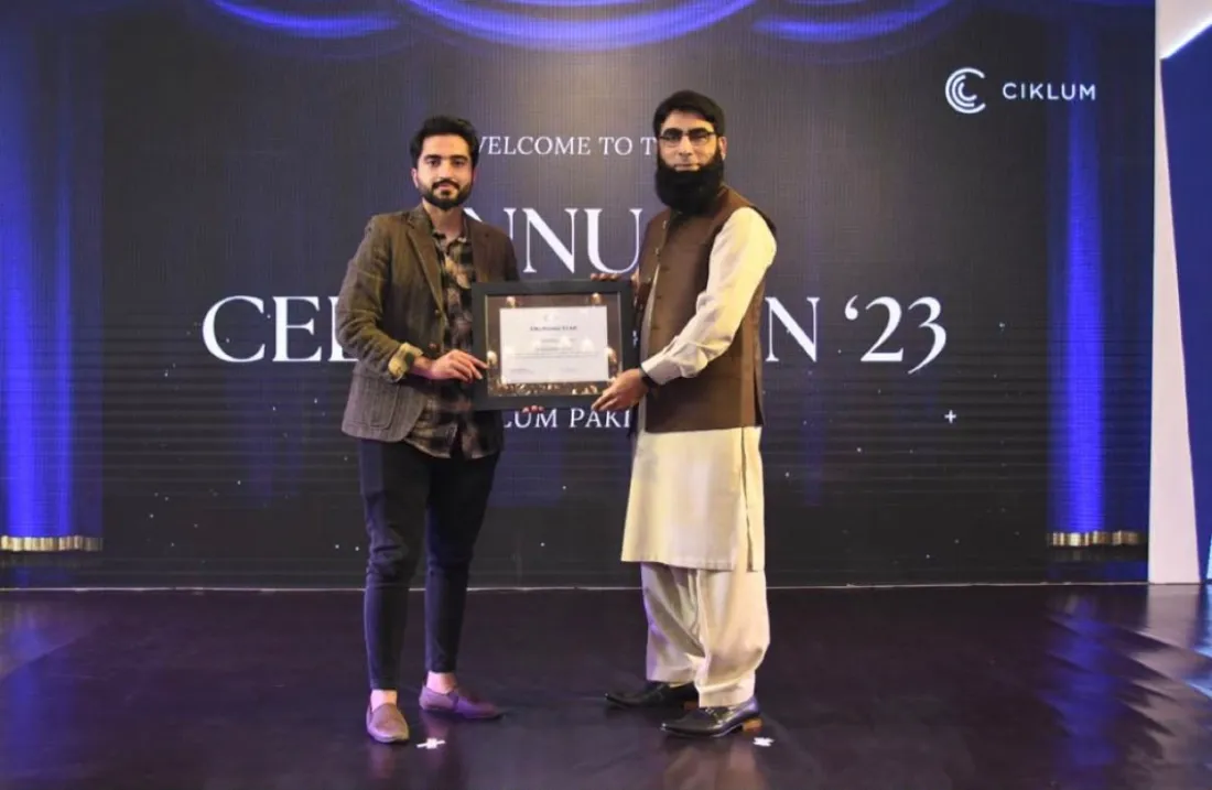 Rizwan receiving recognition on stage at a Ciklum event in 2023