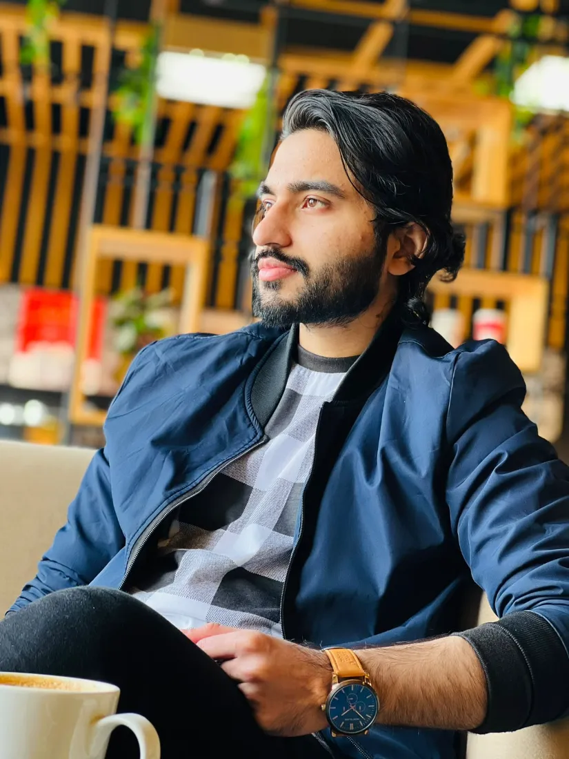 Muhammad Rizwan Aslam seated, smiling at the camera